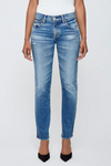 Blue jeans worn by a person on a white background