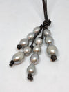 close up of pearls on leather lariat