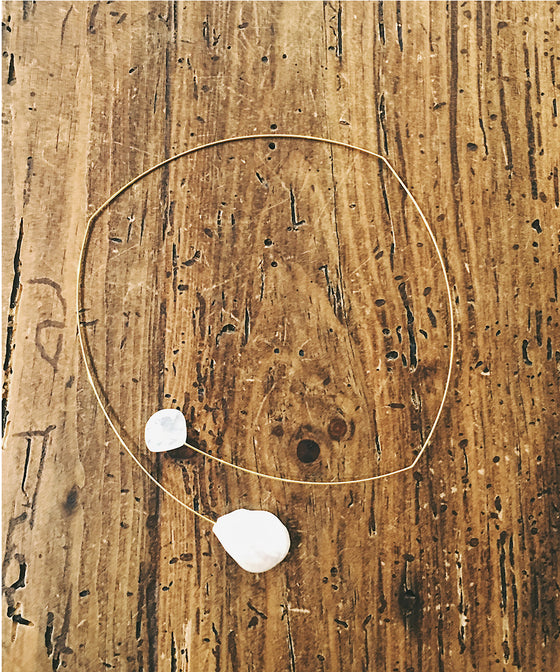This light and airy necklace features a freshwater pearl and rainbow moonstone floating on a wire choker.