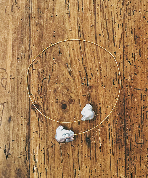 This light and airy necklace features two grey freshwater pearls on a wire choker. The wire is Sterling Silver with 22kt gold vermeil.