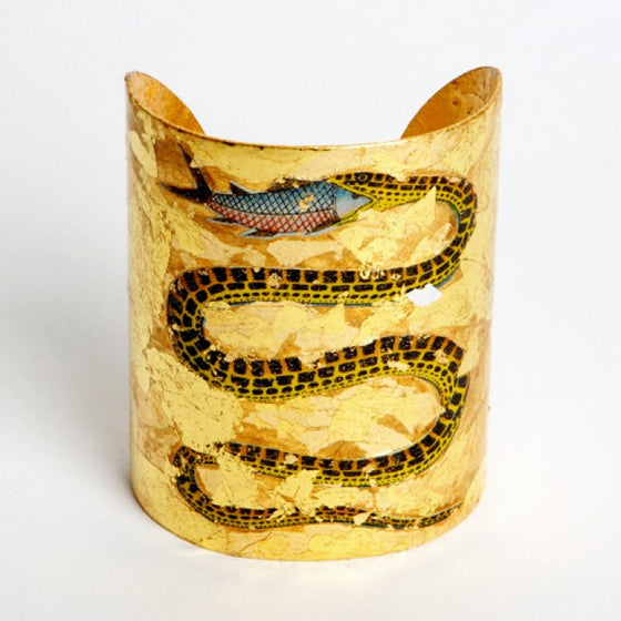 Beautiful Evocateur gold leaf cuff, featuring a serpent eating a fish, available at Patricia
