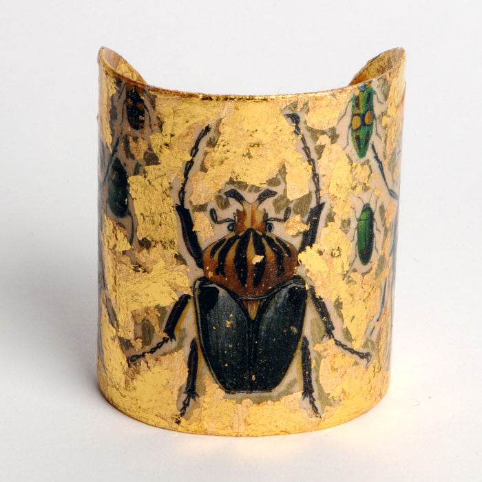 Beautiful Evocateur gold leaf cuff, featuring images of various garden beetles, available at Patricia