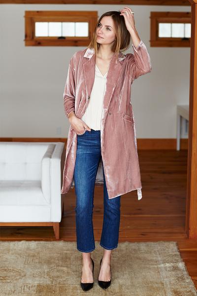 Front standing view of model in jeans, white tee, and blush Studio Coat