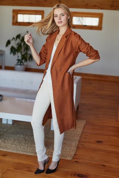 Long sleeve linen coat on model in white pants