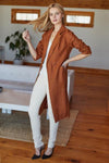 Long sleeve linen coat on model in white pants