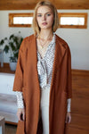 Close up of model in linen coat and floral blouse