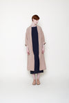 woman in swing coat over black dress