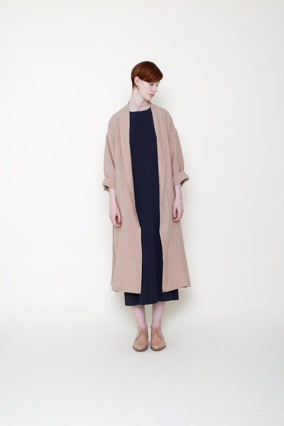 woman in swing coat over black dress