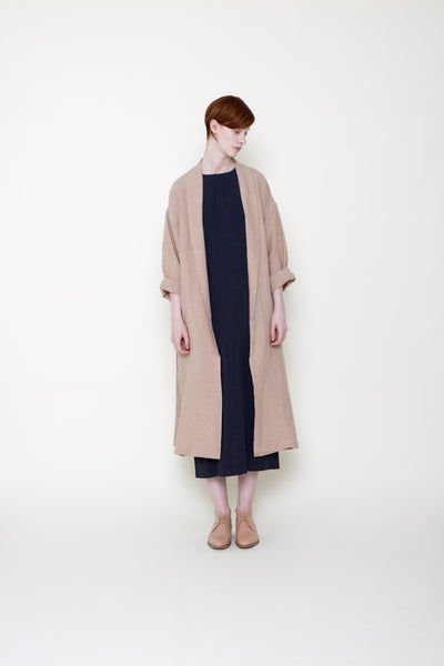 woman in swing coat over black dress